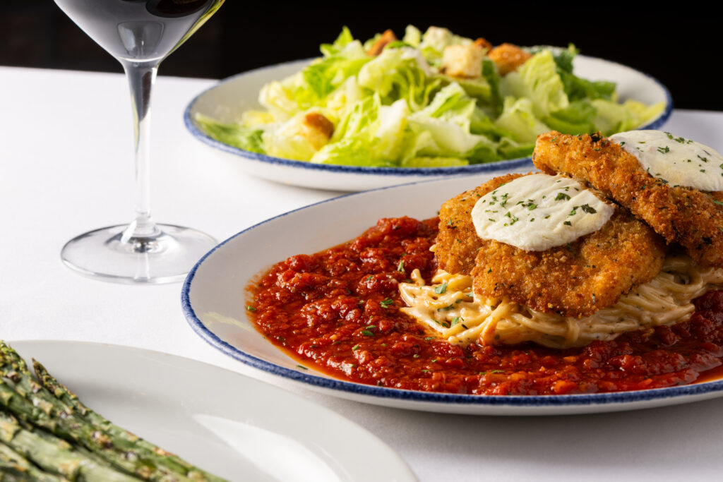 Chicken Parmasean with a side salad and a glass of wine